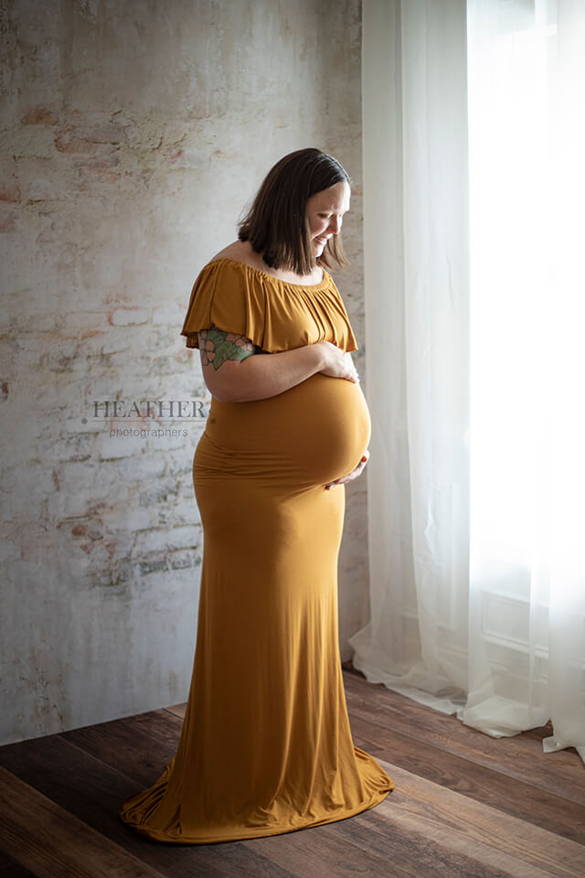 Pregnant Woman in front of urban brick wall backdrop