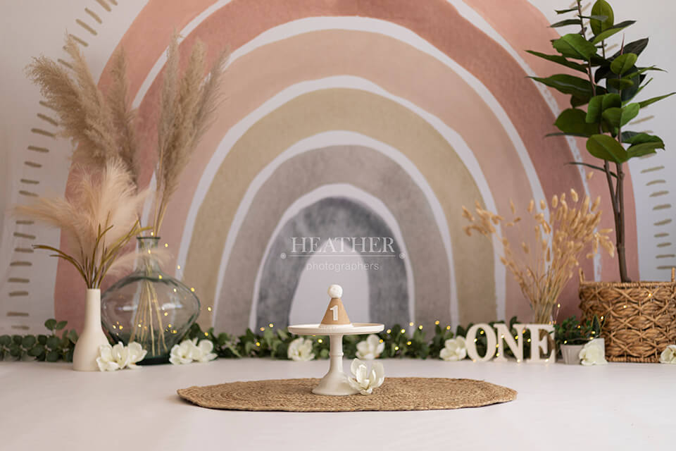 A vibrant and eye-catching backdrop featuring a rainbow in boho colors and patterns.