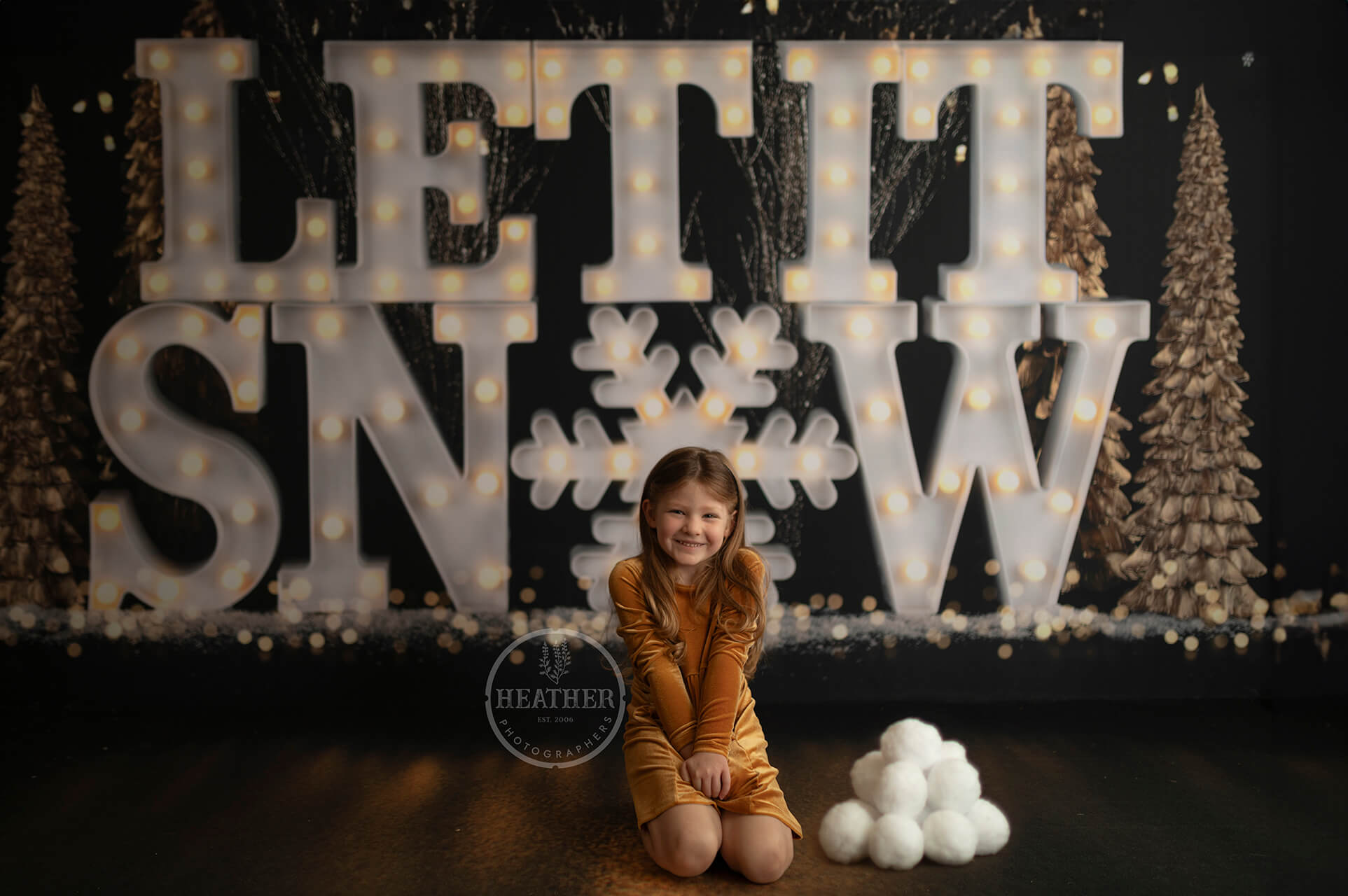 Embrace the magic of winter with a backdrop featuring the iconic phrase Let it Snow written in festive typography