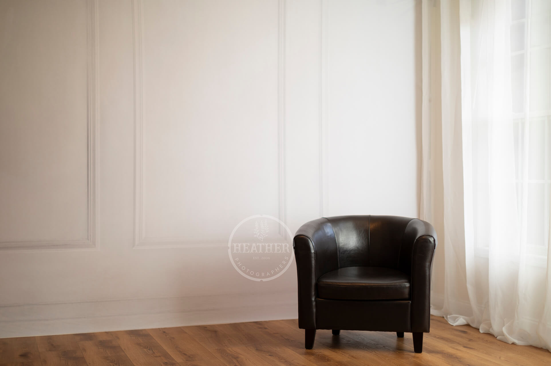 dark brown chair against white wall 