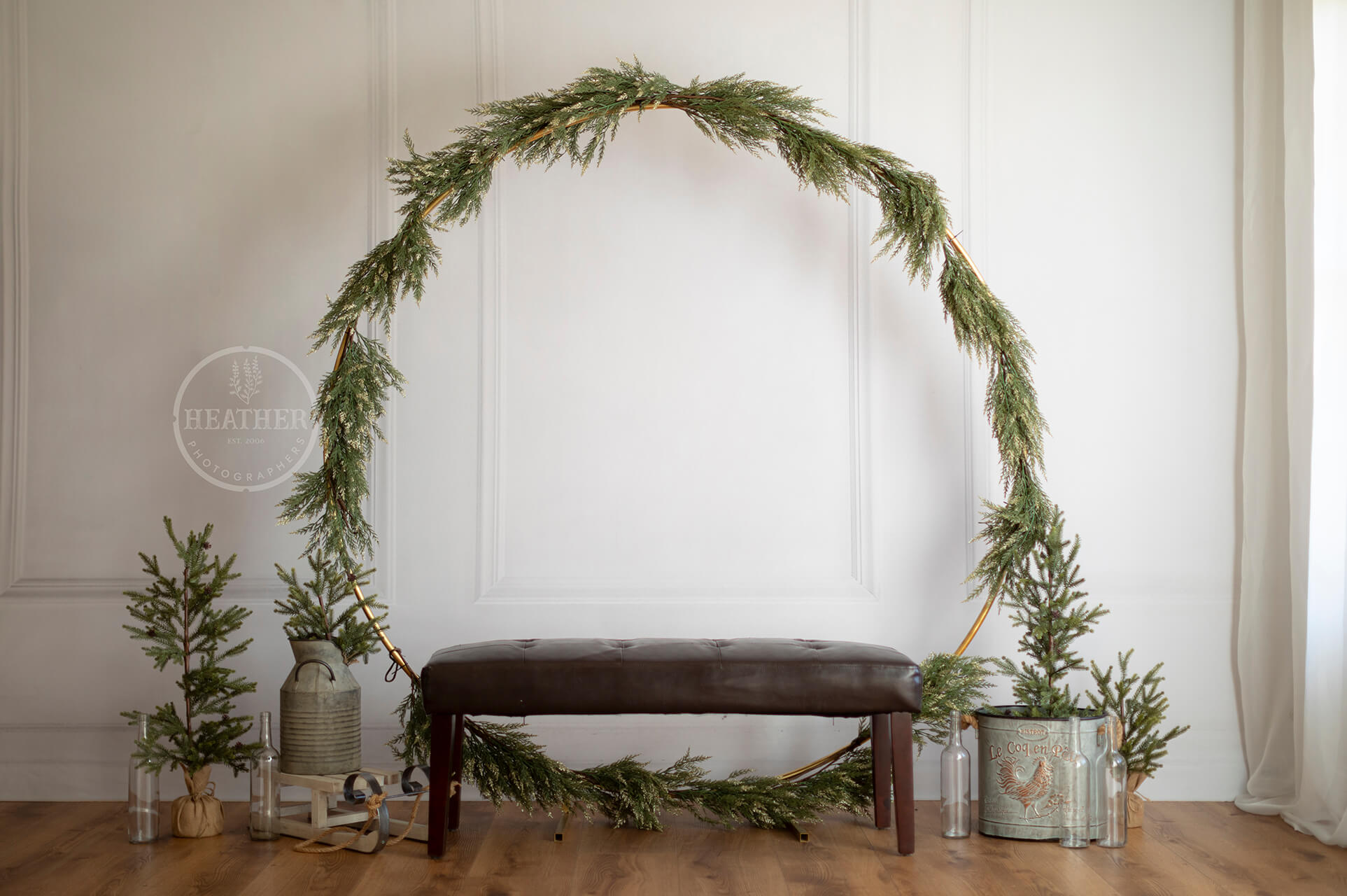 Step into a winter wonderland with a lush evergreen arch backdrop