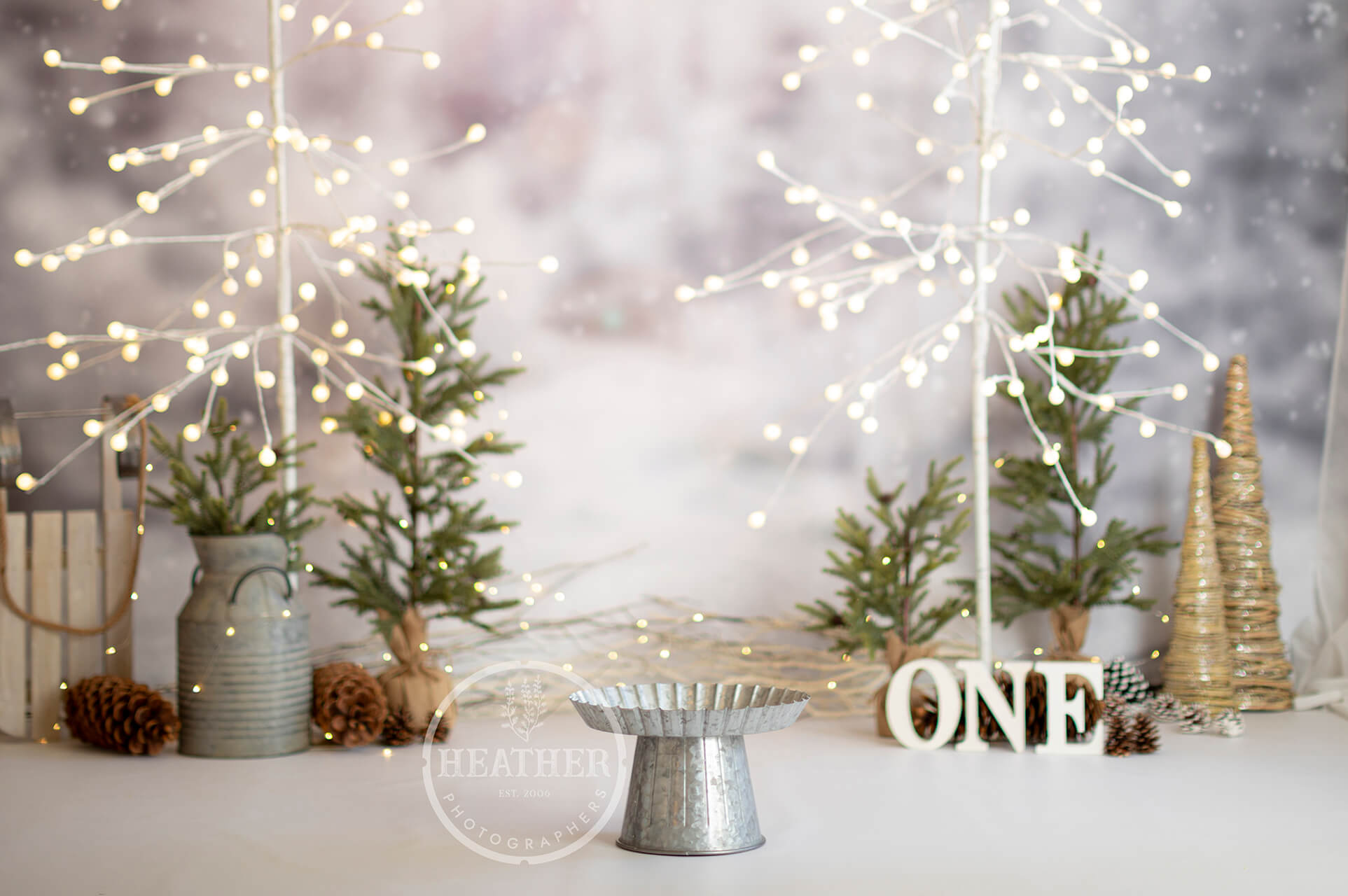 A festive backdrop featuring snowflakes, snowmen, and the number one, perfect for celebrating a first birthday with a winter theme.